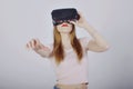 Girl on a white background plays virtual reality. Games and films vr. Emotions