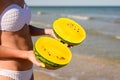 A girl in a white bathing suit holds two halves of a yellow watermelon in her hands. Royalty Free Stock Photo