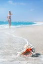 Girl in white bikini on the sea sandy beach