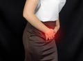 A girl in a white blouse holds onto the groin of the lower abdomen, her stomach hurts, monthlies Royalty Free Stock Photo