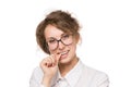 Girl in a white blouse stands on a white background, gestures, emotions on her face