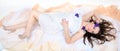 Girl in a white cloth lies on fabrics Royalty Free Stock Photo