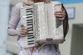 Girl in white clothes plays the white accordion Royalty Free Stock Photo