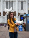 A girl with a white dove on a Moscow street in summer