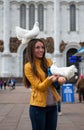 A girl with a white dove on a Moscow street in summer