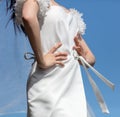 Girl in a white dress on the background of the blue sky Royalty Free Stock Photo