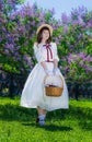 Girl with a basket in her hands in a walk in garden Royalty Free Stock Photo