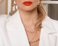 Girl in a white dress with a diamond neck.The bride fixes decoration of a jewel on the neck