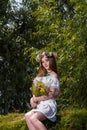 Girl in white dress and flowers wreath on green willow background. 7th July, traditional slavic holiday with fortune-telling Royalty Free Stock Photo