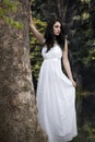 Girl in white dress in forest