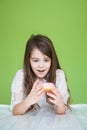 Girl in a white dress is going to eat a sweet donut Royalty Free Stock Photo