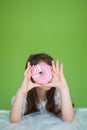 Girl in a white dress is going to eat a sweet donut Royalty Free Stock Photo
