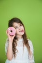 Girl in a white dress is going to eat a sweet donut Royalty Free Stock Photo