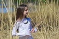 Girl in white dress among the high dry grass Royalty Free Stock Photo