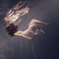 Girl with long hair swims underwater