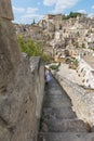 Girl with white dress on the stair, Matera, Basilicata, Italia.