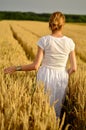 Girl in white dress in the wheat field Royalty Free Stock Photo