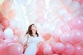 Girl in white flies among pink balloons Royalty Free Stock Photo