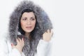 Girl in a white fur coat with a hood on her head