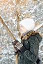 Girl in a white hat with cup of tea. Winter, outdoors. Side view Royalty Free Stock Photo