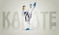 A girl in a white kimono with a black belt trains, oriental style karate. Royalty Free Stock Photo