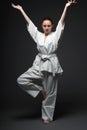 Girl in white kimono standing in traditional pose