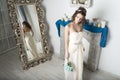 Girl in white near the mirror and the fireplace. Royalty Free Stock Photo