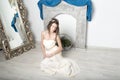 Girl in white near the mirror and the fireplace. Royalty Free Stock Photo