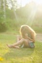 Girl with white pedigreed cat in her arms in a blue sundress