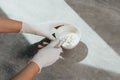 A girl in white protective gloves squeezes hair dye into an oxidizer. colorist at work close-up hair care hair mask hair