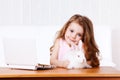 Girl with white rabbit and laptop Royalty Free Stock Photo