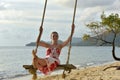 Girl in white with red flowers dress on the beach Royalty Free Stock Photo