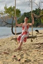 Girl in white with red flowers dress on the beach Royalty Free Stock Photo