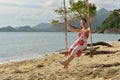 Girl in white with red flowers dress on the beach Royalty Free Stock Photo