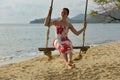 Girl in white with red flowers dress on the beach Royalty Free Stock Photo