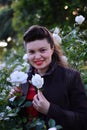 Portrait of a girl in white rose garden