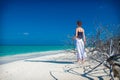 Girl on white sand beach with thorny