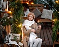 A girl in a white scarf with a Sparkler in a Christmas gazebo