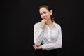 Girl in a white shirt is afflicted on a black background Royalty Free Stock Photo