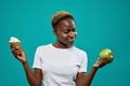 Girl in white shirt keeping healthy and unhealthy food