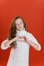 Merry Christmas girl in white sweater on bright red vivid color background Royalty Free Stock Photo