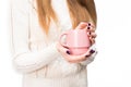 A girl in a white sweater with dark manicure holds a mug of warm drink in her hands in the studio. Isolated Royalty Free Stock Photo