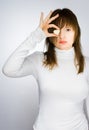 Girl in white sweater holding heart-shaped candy