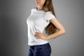 Girl in white t-shirt and blue jeans. Ready for your design. Closeup. Isolated Royalty Free Stock Photo