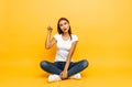 Girl in a white t-shirt, came up with a great idea, on a yellow background