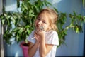 A girl in a white T-shirt holds a Mongolian gerbil on her hand. Baby and our smaller brothers