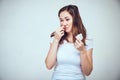 A girl in a white T-shirt is testing different medications for a stuffy nose. Toned