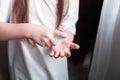 A girl in a white T-shirt uses an antiseptic hand spray