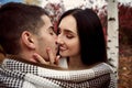 Girl with white teeth and black hair holds the guy`s face and st Royalty Free Stock Photo