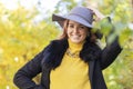 Girl white toothed smile, young happy woman whitened teeth in grey hat in autumn in the park. closeup portrait of stylish smiling Royalty Free Stock Photo